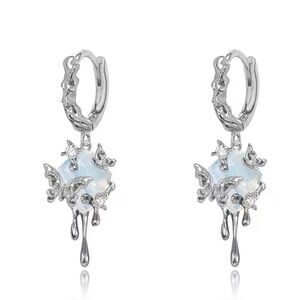 Super cute silver earrings with iridescent stone and dripping butterflies
